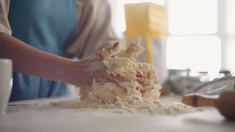 woman-is-kneading-dough-in-table-in-home-kitchen-cooking-pizza-for-family-for-breakfast-closeup-of-hands